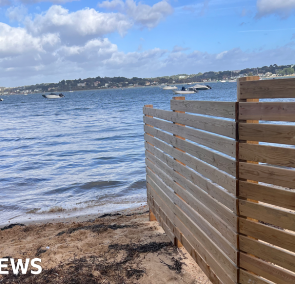 Sandbanks residents seek legal advice after fence blocks off beach